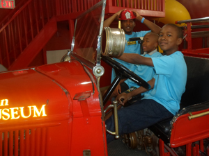 Childrens museum posing in fire truck