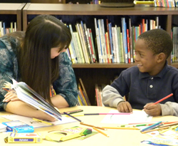 child reading with mentor